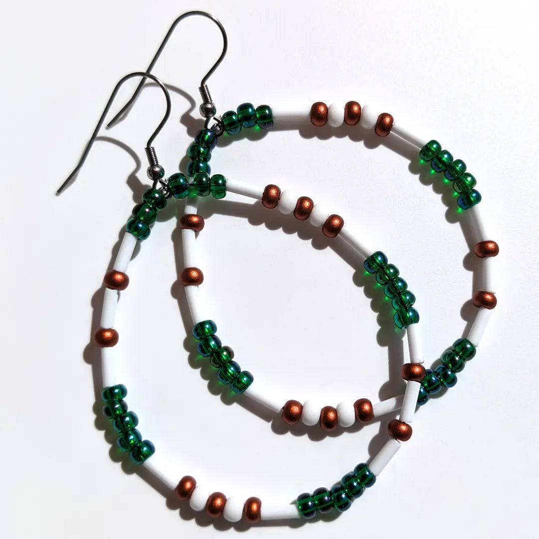 Mesmerizing Mermaid Luster Morse code earrings, handcrafted with serene blue-green & copper Czech glass beads, hold the secret message “XOXO.”