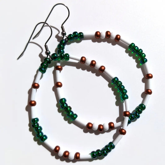 Mesmerizing Mermaid Luster Morse code earrings, handcrafted with serene blue-green & copper Czech glass beads, hold the secret message “XOXO.”