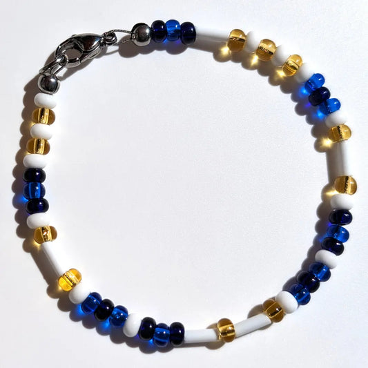 Cheer on the Milwaukee Brewers with this Morse code bracelet, handcrafted with 100% stainless steel coupled with blue, dark blue, and yellow glass beads.