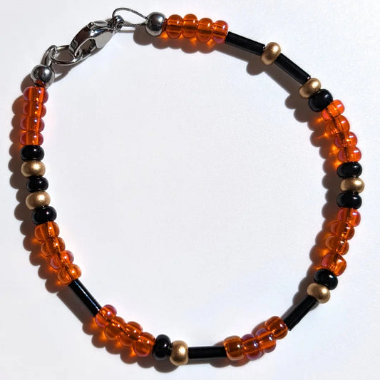 Cheer on the San Francisco Giants with this Morse code bracelet, handcrafted with 100% stainless steel coupled with black, gold, and orange glass beads.