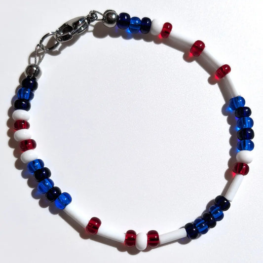 Cheer on the Toronto Blue Jays with this Morse code bracelet, handcrafted with 100% stainless steel coupled with red, blue, and dark blue glass beads.