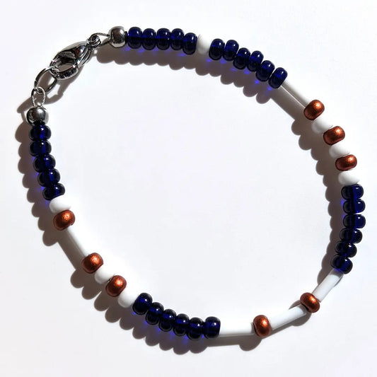 Mysterious Midnight Luster Morse code bracelet, handcrafted with deep, intense dark blue & copper Czech glass beads, holds the secret message “Love.”