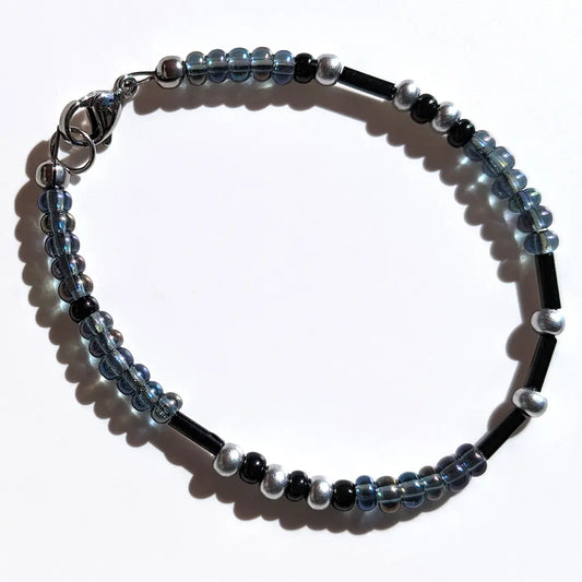 Enchanting Oil Slick Shimmer Morse code bracelet, handcrafted with ethereal iridescent gray & silver Czech glass beads, holds the secret message “Love.”