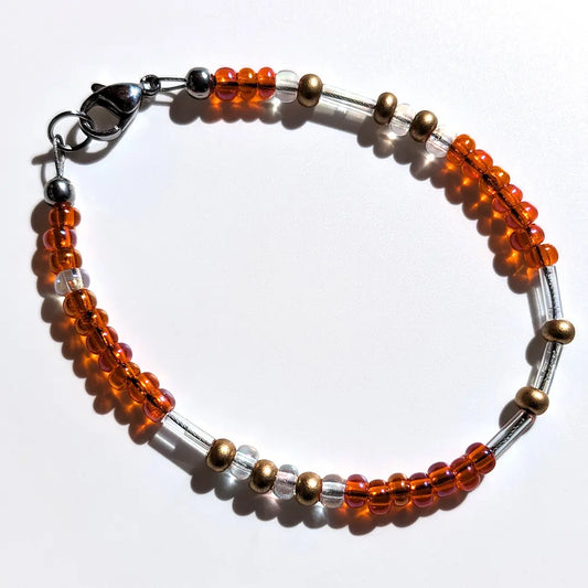 Energetic Tangerine Glitter Morse code bracelet, handcrafted with warm, sun-kissed orange & gold Czech glass beads, holds the secret message “Love.”