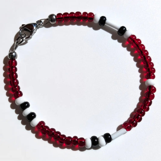 Cheer on the Cincinnati Reds with this Morse code bracelet, handcrafted with 100% stainless steel coupled with red, black, and white Czech glass beads.