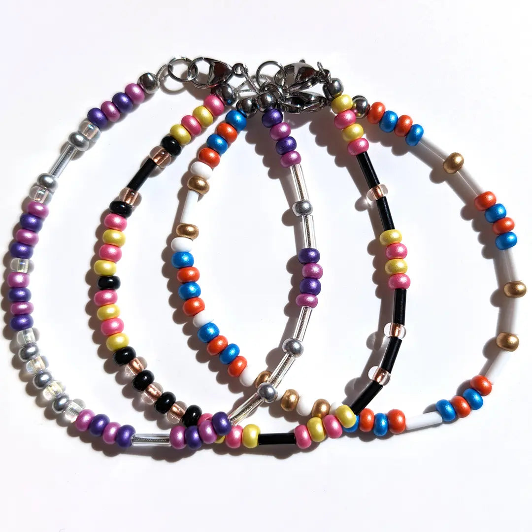 a collection of 3 popular Mother's Day Morse code bracelets with limited time floral beads: Lilac & Lavender, Tulip & Daffodil, and Iris & Marigold.