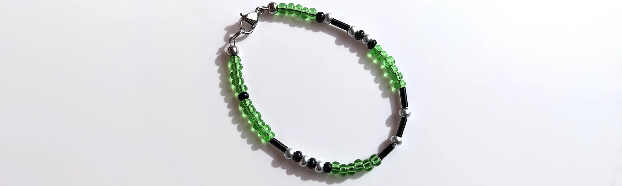 Tranquil Limeade Shimmer Morse code bracelet, handcrafted with lush, calming green & silver Czech glass beads, holds the secret message “Love.”